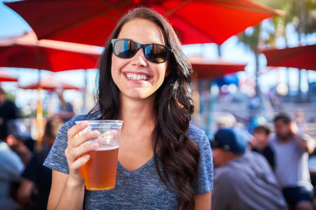 lady holding and drinking beer